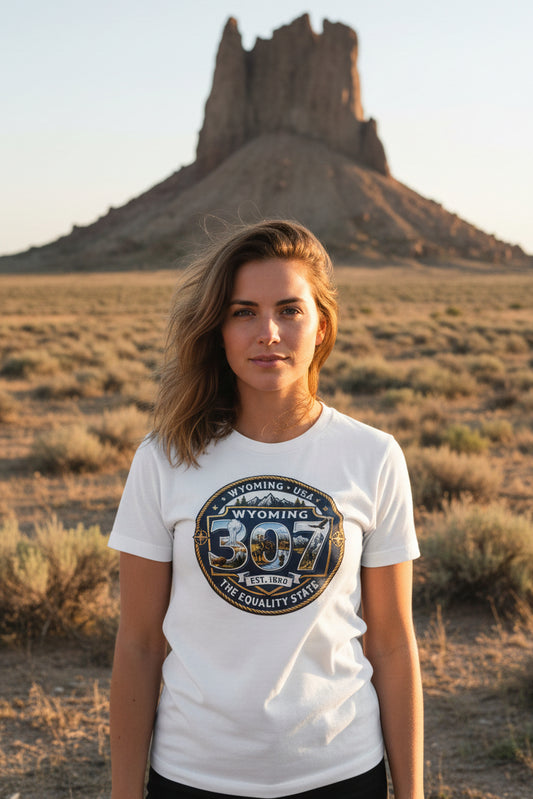 Woman wearing a white t-shirt with a Wyoming design in front of Boars Tusk Monolith