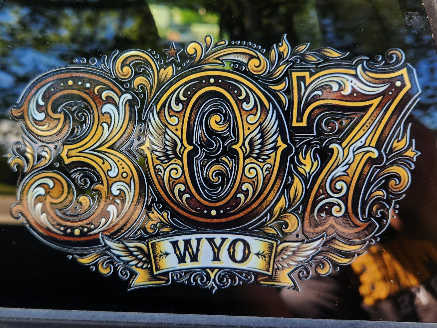 Decorative decal with '307 WYO' on a reflective surface