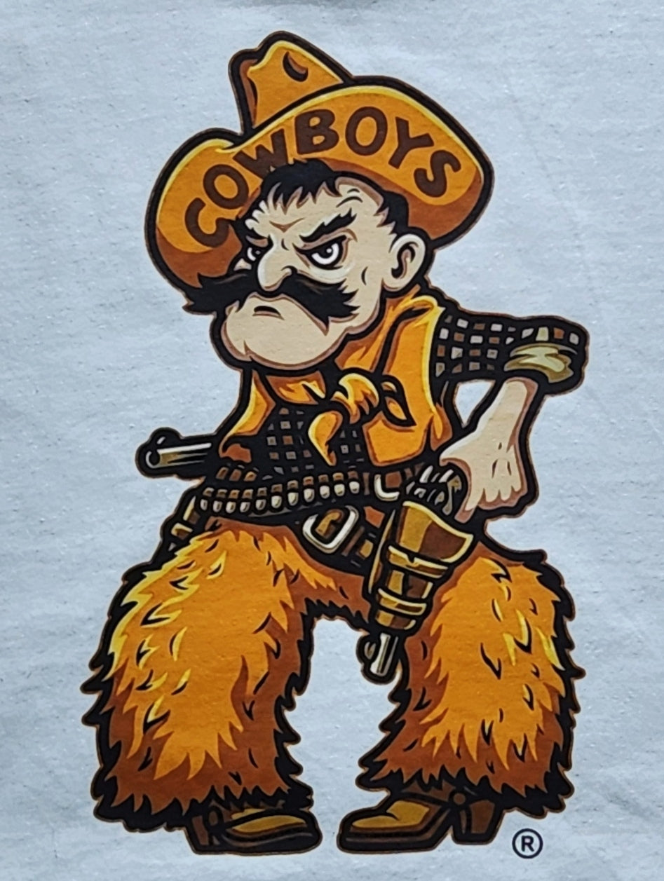 University of Wyoming Cowboy Joe graphic on a white fabric background. The cowboy wears a yellow hat with the word 'COWBOYS' and a matching bandana, with yellow furry chaps and boots, holding a gun.