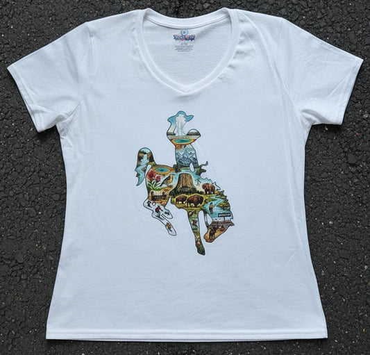 A white short-sleeve V-neck t-shirt with a colorful graphic print of  the Wyoming Bucking Horse logo filled with various outdoor scenes, laid flat on a dark asphalt surface.