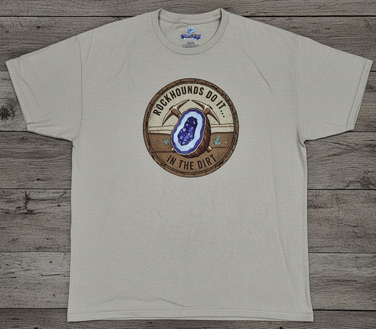 A light beige crewneck t-shirt with a circular graphic on the chest featuring a geode illustration and the text 'ROCKHOUNDS DO IT... IN THE DIRT.'