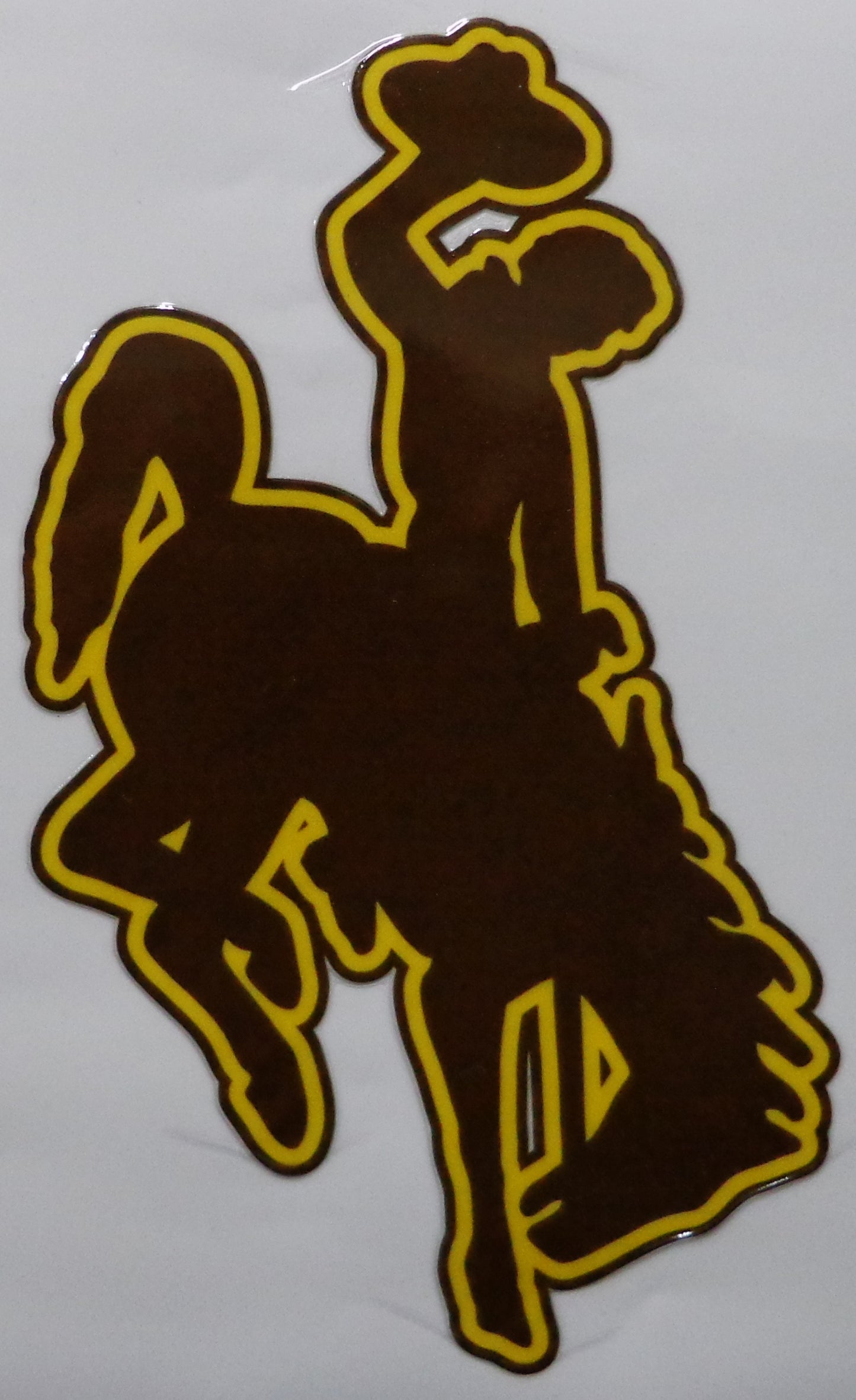 University of Wyoming Bucking Horse logo Sticker featuring a dark brown silhouette of a cowboy riding a bucking horse, outlined in bright yellow.