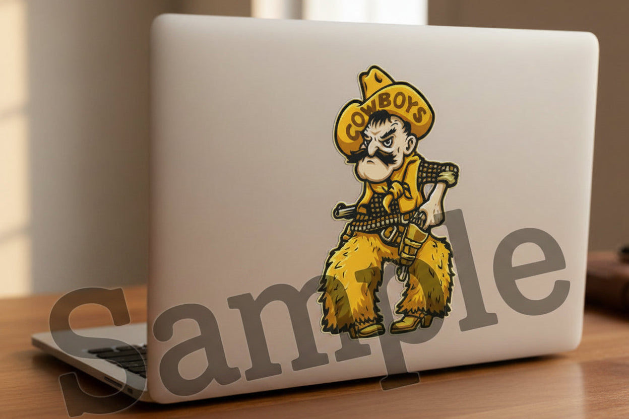 A silver laptop on a wooden desk, showing a University of Wyoming Cowboy Joe sticker on the back cover. 