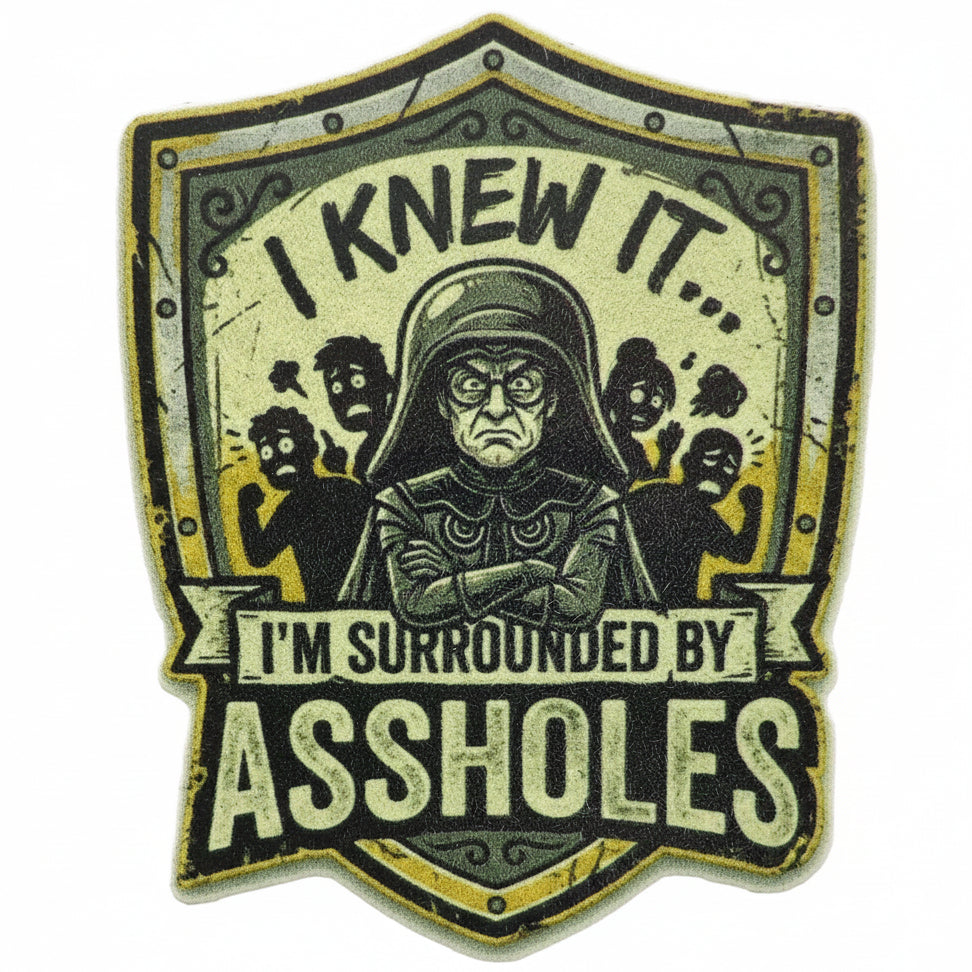 Sticker with text 'I knew it, I'm surrounded by assholes' on a shield design with a Lord Helmet and people in the background. Spaceballs