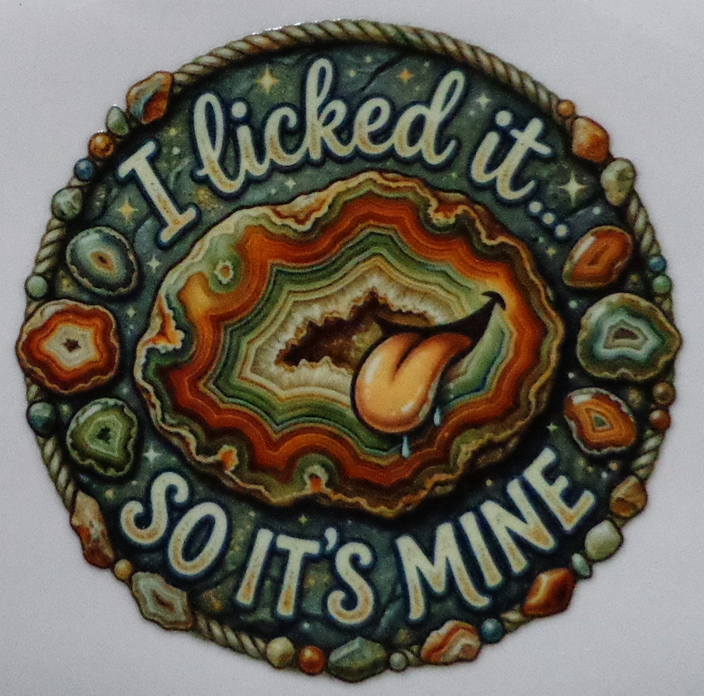 Decorative stone with 'I licked it so it's mine' text and a tongue graphic 