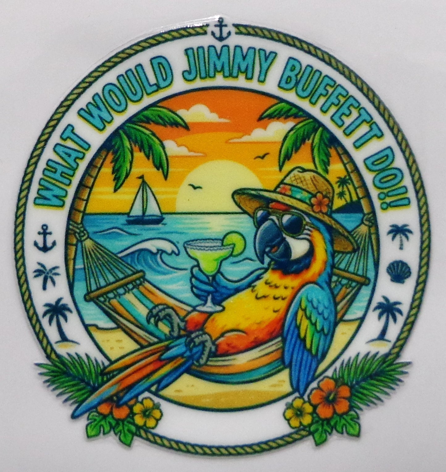A circular novelty sticker or decal featuring a colorful cartoon parrot relaxing in a hammock on a beach, with the text 'WHAT WOULD JIMMY BUFFETT DO!' around the border.
