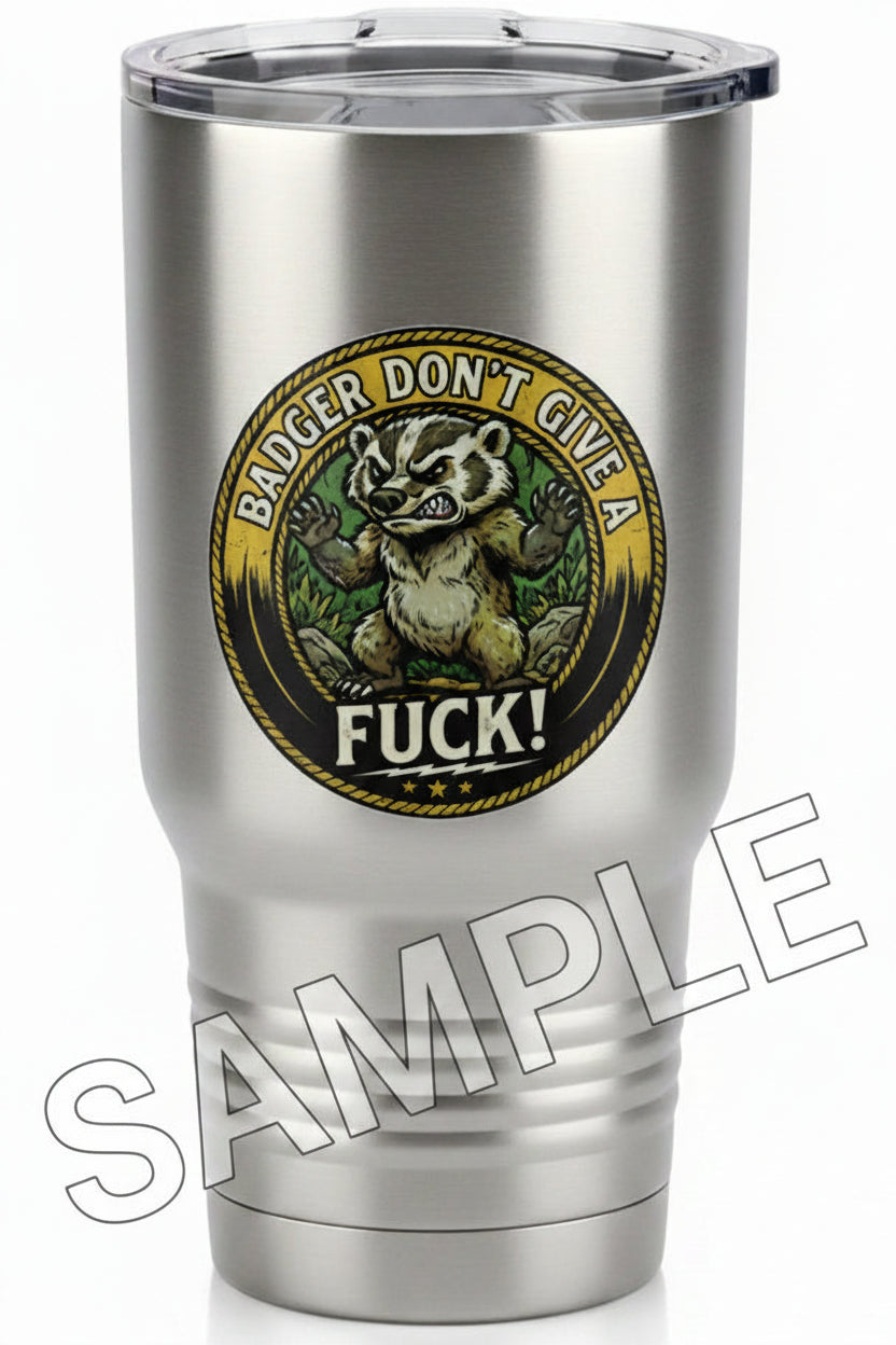 A circular graphic sticker featuring an angry badger with the text 'BADGER DON'T GIVE A FUCK!' on a stainless steel tumbler.