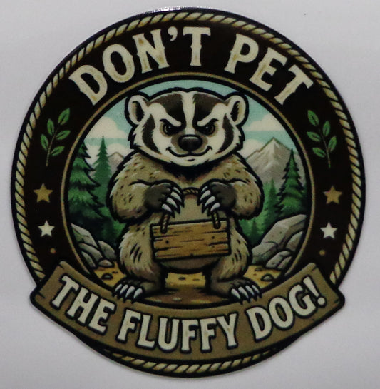 A circular novelty sticker featuring a cartoon badger, with the text 'DON'T PET THE FLUFFY DOG!' around the design.