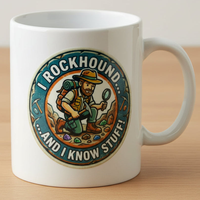 A circular novelty sticker featuring a cartoon rockhound explorer with a backpack, hat, and magnifying glass, surrounded by the text 'I ROCKHOUND... ....AND I KNOW STUFF. On a coffee cup. 