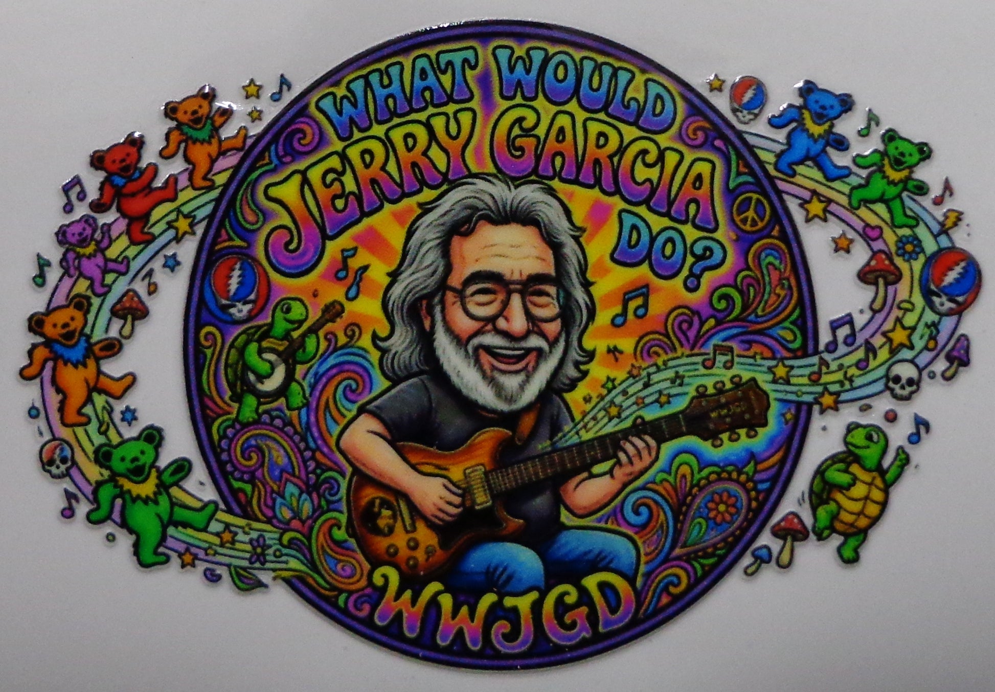 A colorful circular sticker graphic featuring a cartoon portrait of Jerry Garcia playing an electric guitar, surrounded by musical notes, peace signs, mushrooms, and Grateful Dead-style teddy bears. The text reads 'WHAT WOULD JERRY GARCIA DO?' and 'WWJGD'.