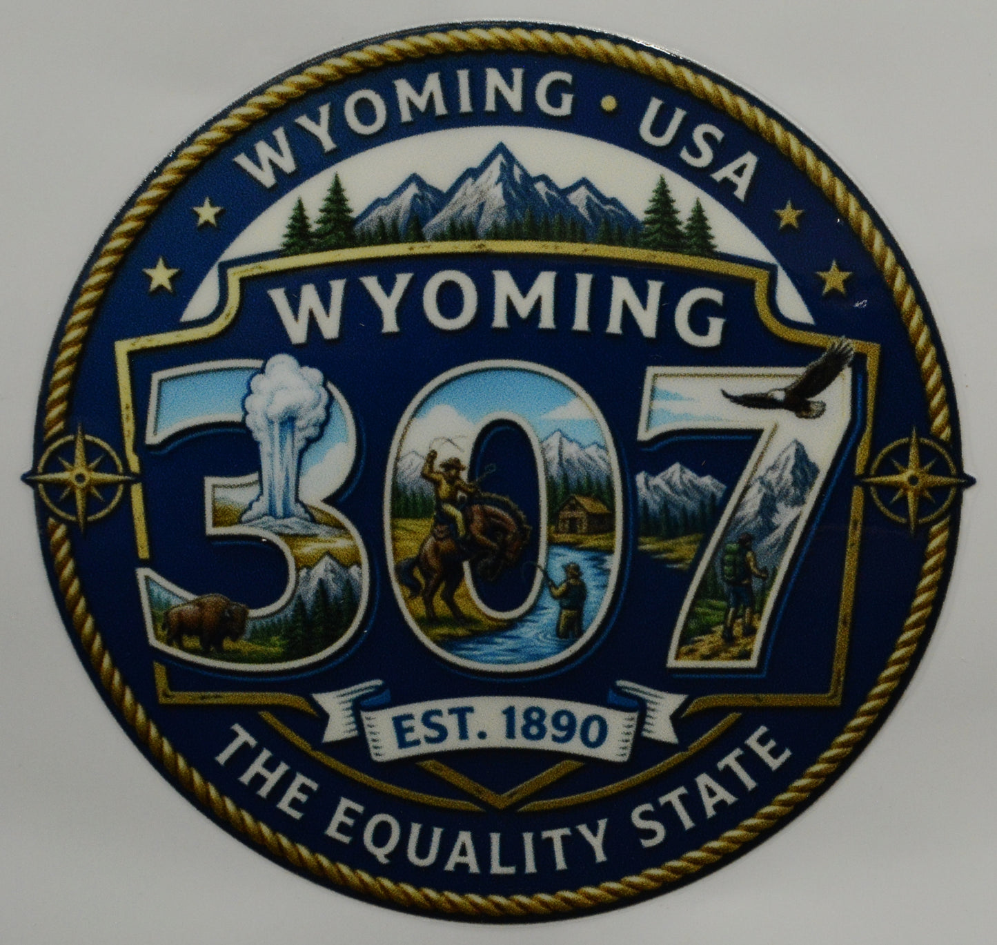 307 Wyoming state emblem with mountains, trees, and landscapes on a blue background.