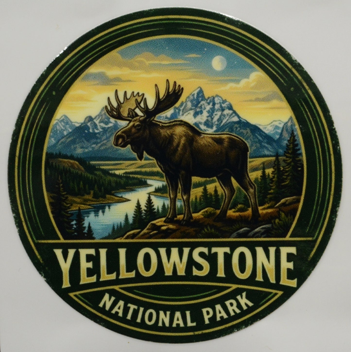 Round sticker with moose and mountain landscape, featuring 'Yellowstone National Park' text.