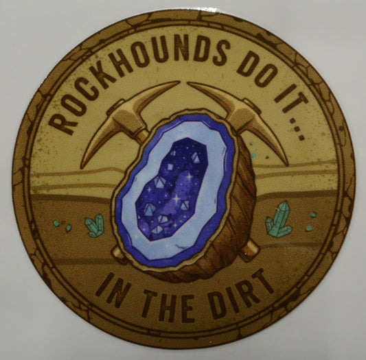 Circular sticker with a geode and pickaxe graphic, text 'Rockhounds do it... in the dirt', on a beige background.