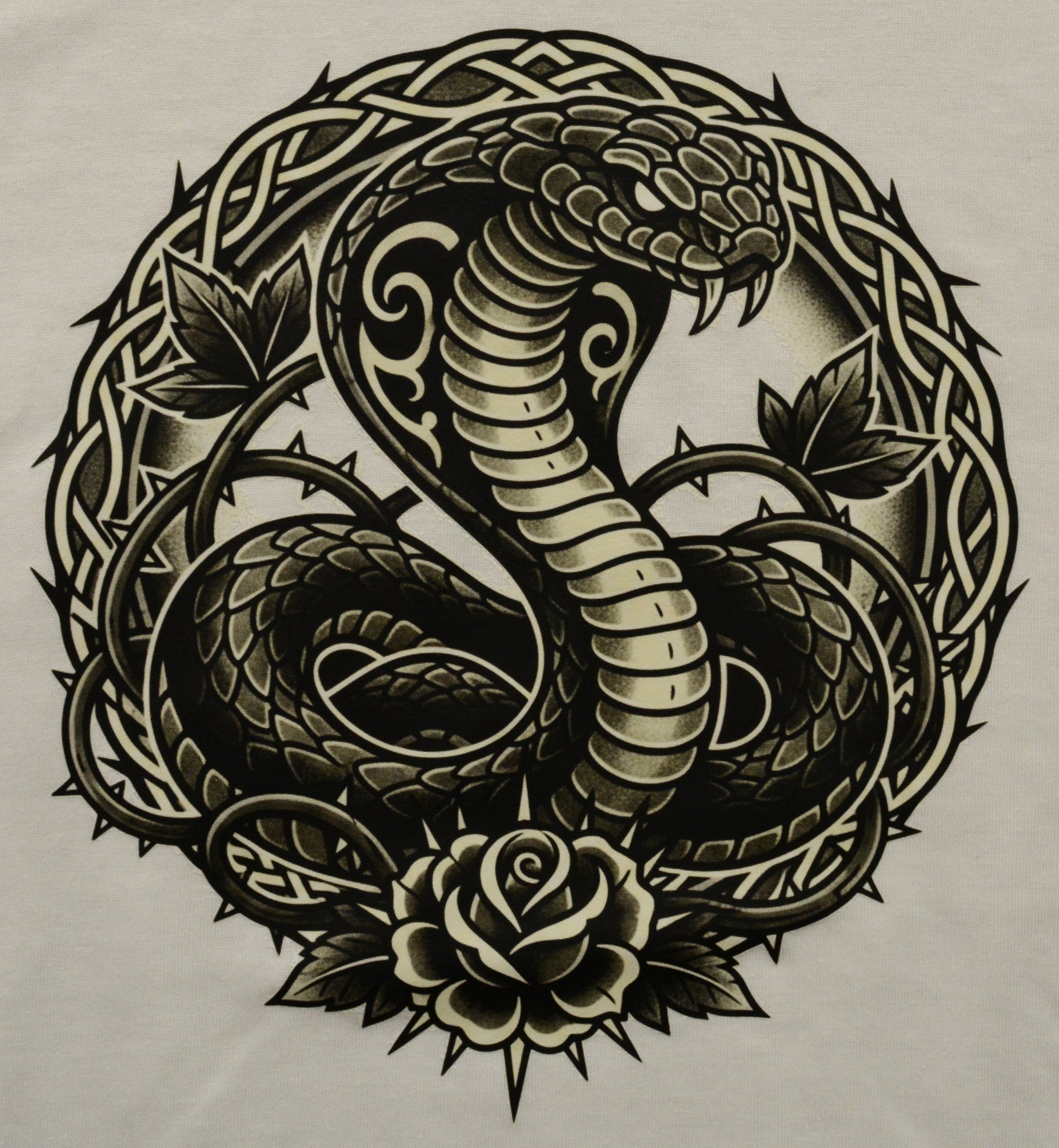 Decorative design of a snake coiled around a rose with intricate patterns on a white background
