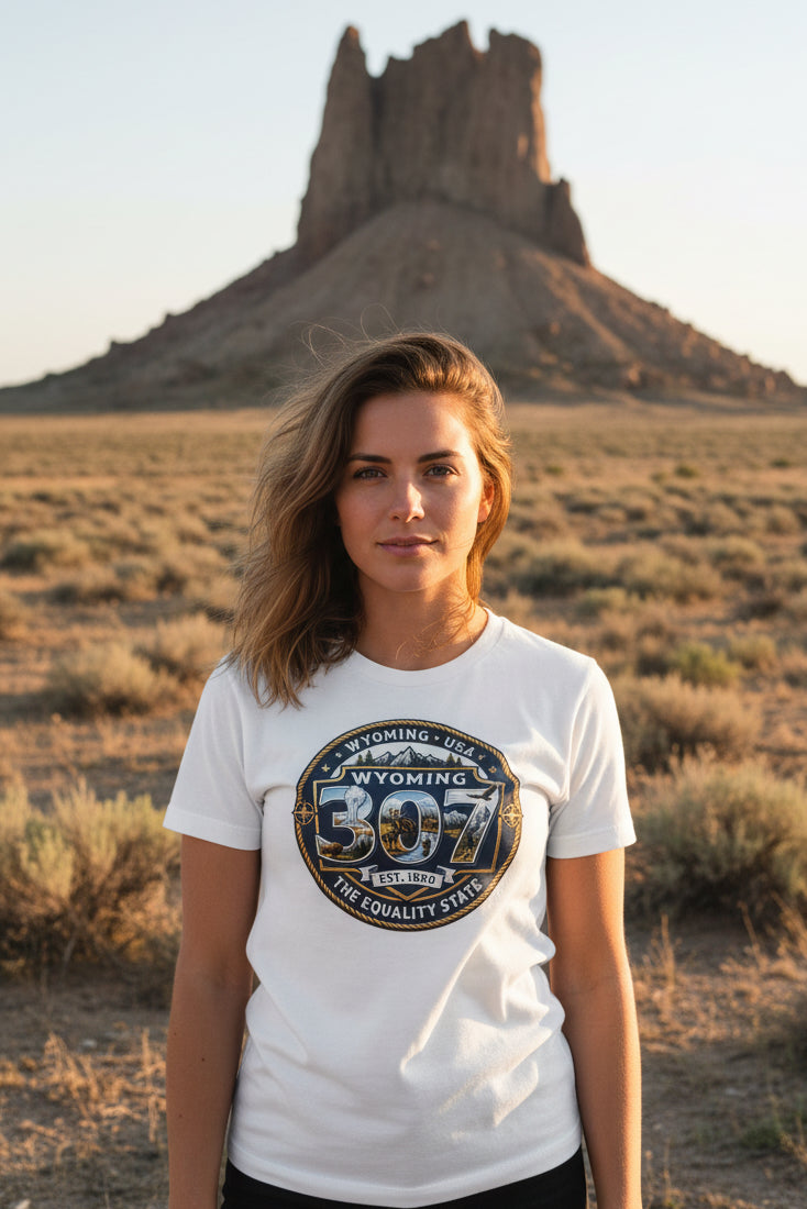 Woman wearing a white t-shirt with a Wyoming design in front of Boars Tusk Monolith 