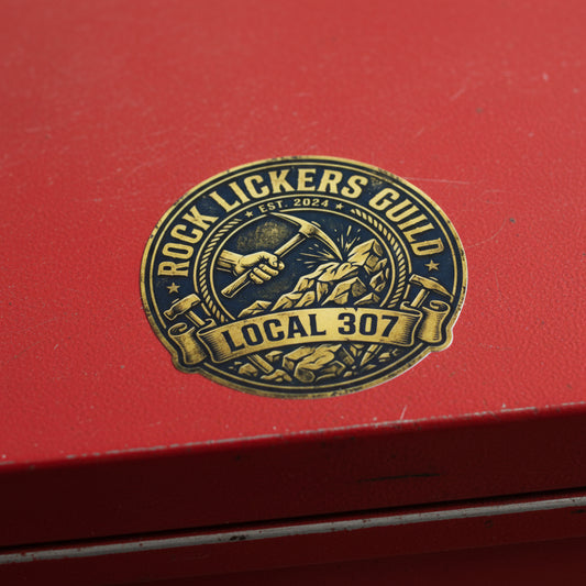 Logo of Rock Lickers Guild Local 307 with a hand holding a pickaxe and mountain.